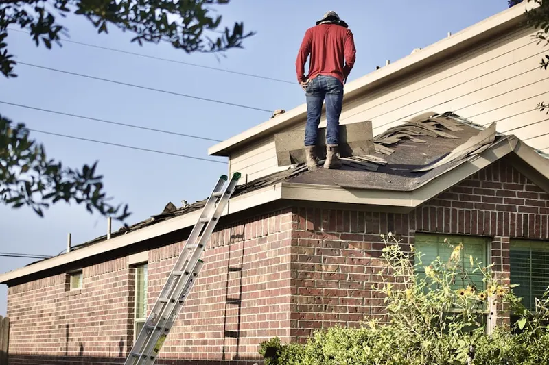 Professional roofer working on a residential roof in Suamico